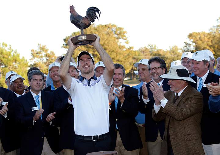 Nick Taylor hoists the trophy after winning the Sanderson Farms Championship trophy Sunday, Nov. 9, 2014, in Jackson, Miss.