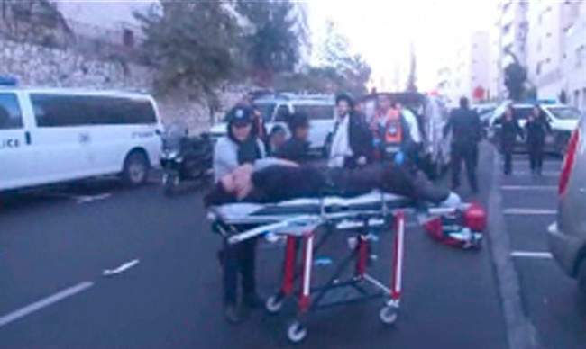 This frame grab from an APTN video shows the scene in Jersualem where two Palestinians stormed a Jerusalem synagogue on Tuesday, Nov. 18, 2014, attacking worshippers praying inside with knives, axes and guns, and killing four. Police killed the attackers in a shootout. (AP Photo/APTN).