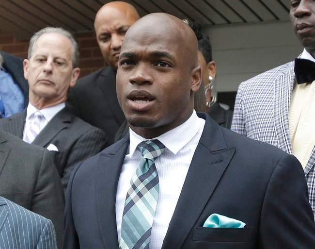 FILE - In this Nov. 4, 2014, file photo, Minnesota Vikings running back Adrian Peterson speaks to the media after pleading no contest to an assault charge in Conroe, Texas. The NFL suspended Adrian Peterson without pay for at least the remainder of the season. 
