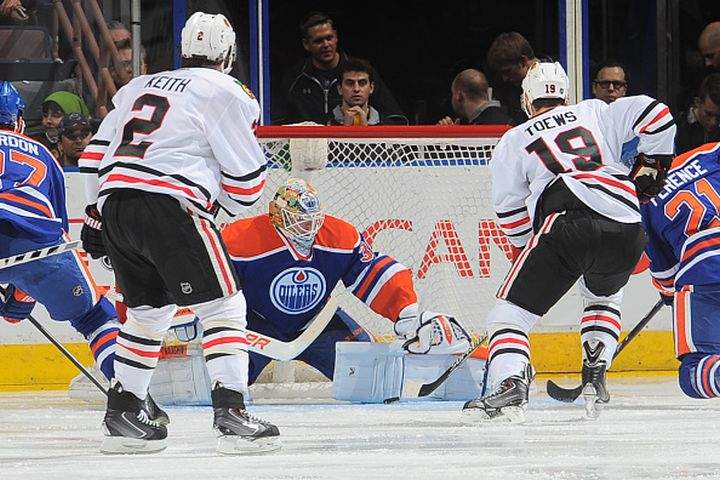 Ben Scrivens #30 of the Edmonton Oilers makes a save on a shot from Jonathan Toews #19 of the Chicago Blackhawks on November 22, 2014 at Rexall Place in Edmonton, Alberta, Canada. 