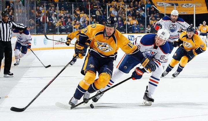 Olli Jokinen #13 of the Nashville Predators skates against Nikita Nikitin #86 of the Edmonton Oilers at Bridgestone Arena on November 27, 2014 in Nashville, Tennessee.