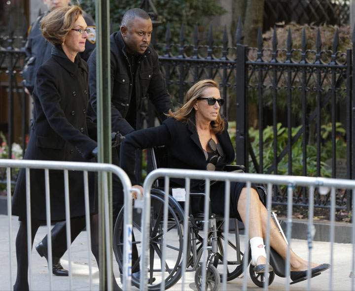 Donna Karan is pushed in a wheelchair to the Church of St. Ignatius Loyola on Manhattan’s Upper East Side before a private funeral for Oscar De la Renta, Monday, Nov. 3, 2014, in New York.