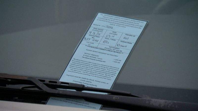A parking ticket left on a driver's windshield.