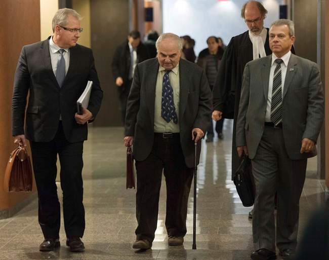 Dr. Joel Paris, center, a psychiatrist who examined Luka Magnotta, leaves the courtroom after testifying at Magnotta's murder trial Tuesday, Nov. 25, 2014 in Montreal.