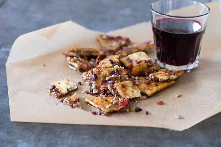 This Nov. 10, 2014 photo shows sweet and spicy cracker bark in Concord, N.H. It's easy to elevate a holiday party spread beyond a bowl of mixed nuts, grapes and a wedge or two of cheese, by using a few more creative offerings.