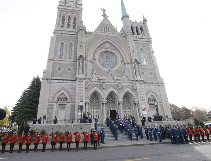 Warrant officer Patrice Vincent’s casket is brought into a cathedral in Longueuil, Que., Saturday, Nov. 1, 2014. Vincent was killed by extremist Martin Couture-Rouleau, whose passport had been seized after he tried to travel to Syria.