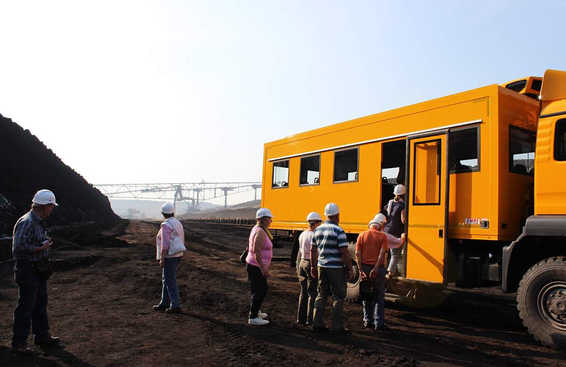 Tourists climb into a bus in the Welzow coal mine