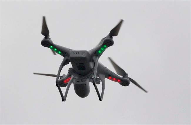  In this March 12, 2014 file photo, a drone flies over the scene of an explosion that leveled two apartment buildings in the East Harlem neighborhood of New York. The government has the power to hold drone operators accountable when they operate the remote-control aircraft recklessly, a federal safety board ruled Tuesday in a setback to small drone operators chafing under Federal Aviation Administration restrictions. 