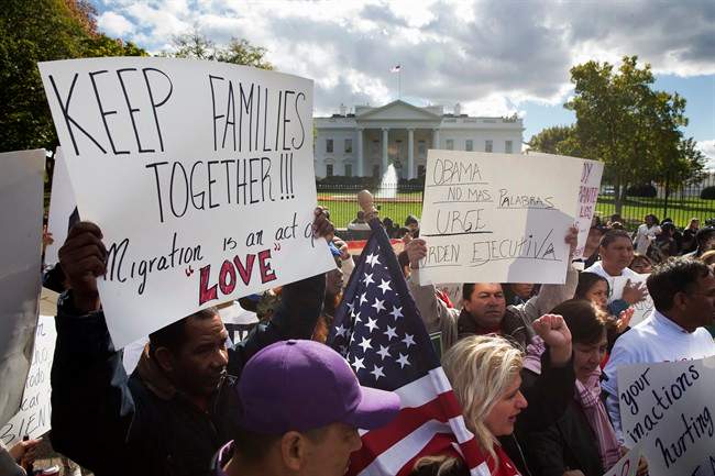 In this Nov. 7, 2014 file photo, people rally for comprehensive immigration reform outside the White House in Washington. 