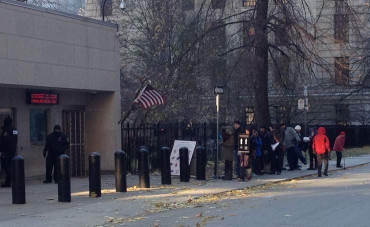 People wait in line outside the U.S. consulate in Toronto on November 14, 2014. 