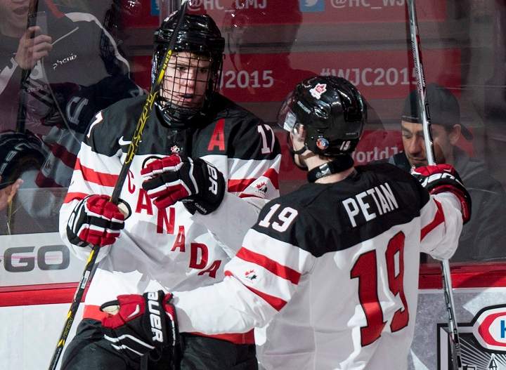 Team Canada's Connor McDavid, left, celebrates his goal against Team Germany with teammate Nic Petan during first period preliminary round hockey action at the IIHF World Junior Championship Saturday, December 27, 2014 in Montreal. 