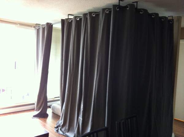 This curtained-off space in a living room is available for $630 a month.