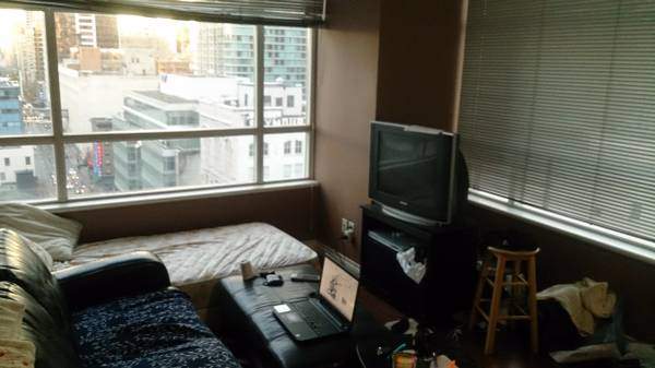 This bed in a living room is available for $650 a month.