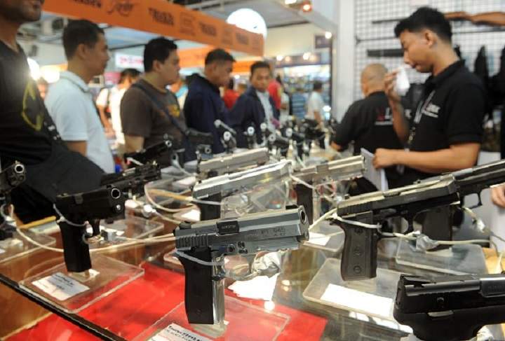 Enthusiasts browse guns on display at a mall in Manila on November 13, 2014.