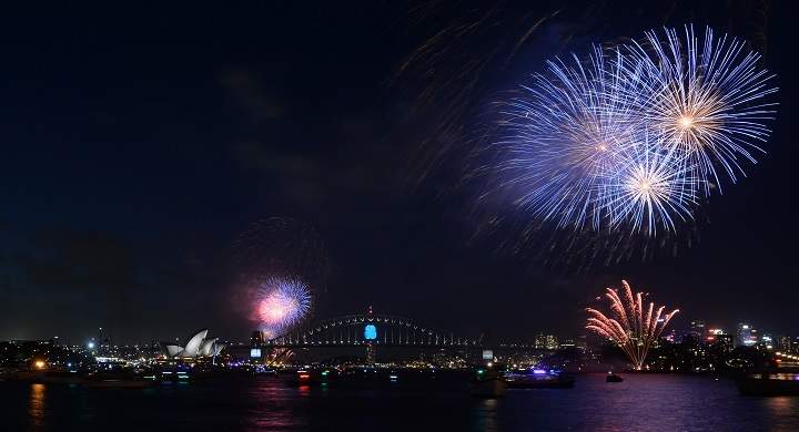 New Year’s Eve fireworks erupt over Sydney’s iconic Harbour Bridge and Opera House (bottom L) during the traditional early family fireworks show held before the main midnight event on December 31, 2014.