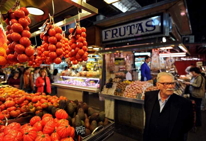 An elderly man passes by market stalls at the La Boqueria market on March 20, 2009 in Barcelona, Spain.