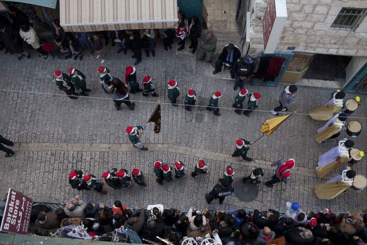 Palestinian children parade outside the Church of the Nativity on December 24, 2014 in Bethlehem, West Bank.