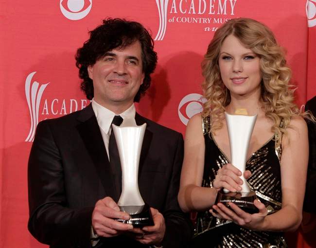 In this April 5, 2009 file photo, producer Scott Borchetta, left, and Taylor Swift pose with the Album of the Year award at the 44th Annual Academy of Country Music Awards in Las Vegas, Nev.