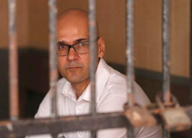 Canadian teacher Neil Bantleman, of Burlington, Ont., sits in a holding cell prior to the start of his trial hearing at South Jakarta District Court in Jakarta, Indonesia, Tuesday, Dec. 2, 2014. 