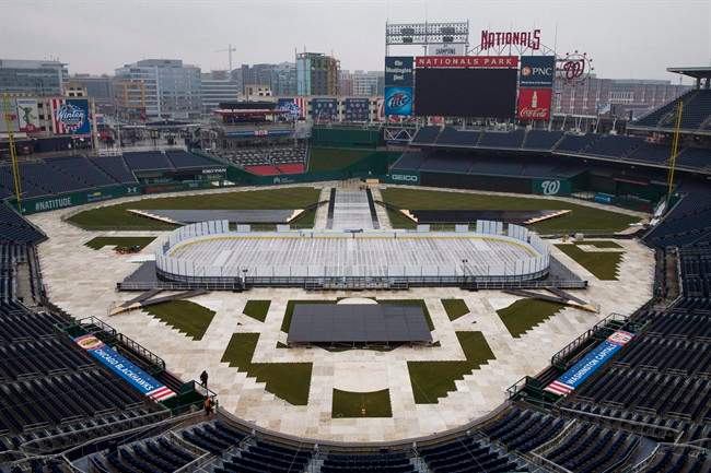 Construction crews work on preparing Nationals Park baseball stadium for the 2015 NHL Winter Classic in Washington on Dec. 22, 2014.