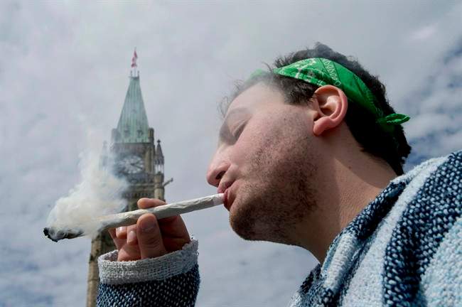 Once widely reviled by society as the demon weed, marijuana is increasingly being viewed as a potentially beneficial medication and a substance that some respected health organizations want legalized and sold like alcohol, in government-controlled outlets. At the same time, polls suggest many Canadians' attitudes toward the illicit drug are also softening. So with a federal election in the offing, and the Liberal platform calling for decriminalization, could 2015 be the year when smoking pot becomes legit? A man is shown smoking a joint at the Fill the Hill marijuana rally on Parliament Hill in Ottawa on Sunday, April 20, 2014.