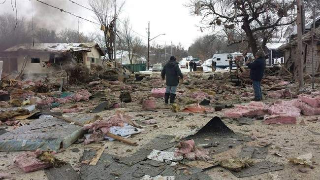 Debris from an explosion litters a street in Regina Beach, Sask., on Dec. 3, 2014.