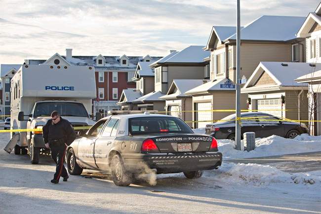 Police investigate the scene where multiple deaths occurred in a north Edmonton home overnight in Edmonton, Alberta on Tuesday, December 30, 2014. THE CANADIAN PRESS/Jason Franson.