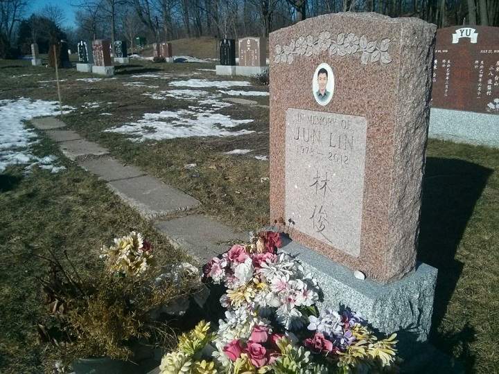 A glimpse of the gravestone marking where Jun Lin is buried in Montreal on December 29, 2014.
