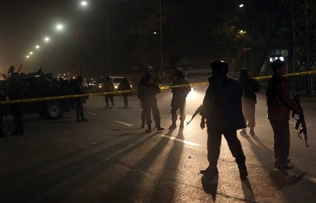 Afghanistan's security forces walk around the French Cultural Center, which was targeted by a suicide attacker in Kabul, Afghanistan on Thursday, Dec. 11, 2014.