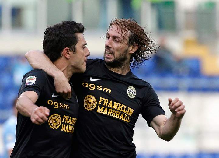 Hellas Verona midfielder Marquinho, of Brazil, left, celebrates with his teammate midfielder Marco Donadel after he scored during an Italian Serie A soccer match between Lazio and Verona at Rome's Olympic stadium, Monday, May 5, 2014. 