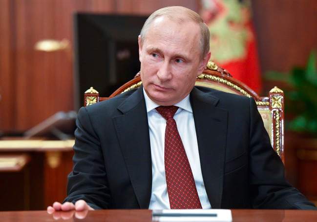 Russian President Vladimir Putin meets with Russia's chief rabbi Berel Lazar and Chairman of Federation of Russia's Jewish Organizations Alexander Boroda in the Kremlin in Moscow, Russia, Wednesday, Dec. 17, 2014.