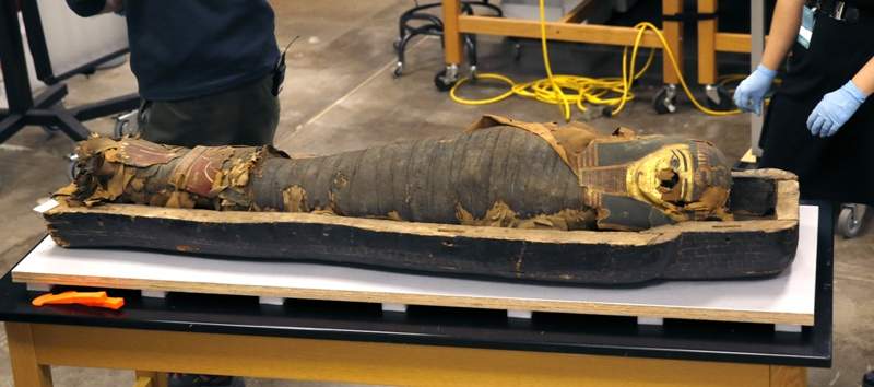In this photo taken Friday, Dec. 5, 2014, in Chicago, the mummified body of Minirdis, a 14-year-old Egyptian boy lies in his opened coffin,