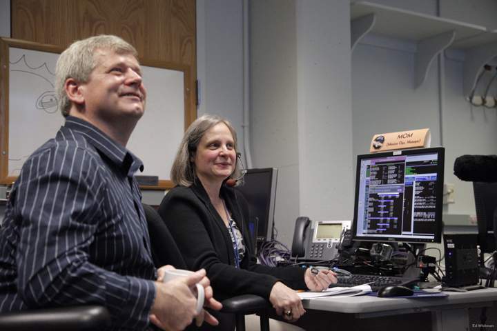 New Horizons Mission Operations Manager Alice Bowman and operations team member Karl Whittenburg watch the screens for data confirming that the New Horizons spacecraft had transitioned from hibernation to active mode on Dec. 6.