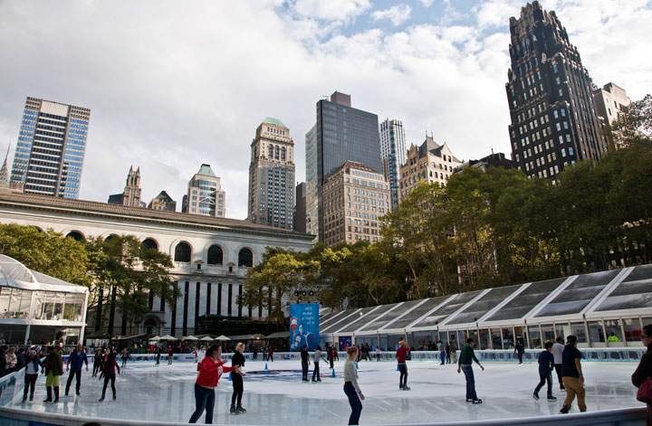 In this Oct. 21, 2014 file photo, skaters take to the ice during opening day of the Bryant Park skating rink in midtown New York. The rink will be open seven days a week until March 1, 2015. Admission to the rink and lockers are free, but if you don’t have your own skates, you do have to pay for rentals.