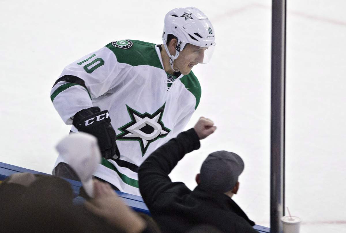 A fan cheers for Dallas Stars' Shawn Horcoff  after he scores against the Edmonton Oilers during a shoot out, Sunday December 21, 2014. 