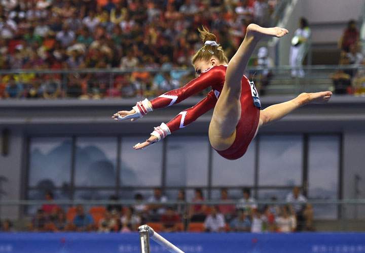 Switzerland’s Ilaria Kaeslin performs on the uneven bars during the women’s qualification at the Gymnastics World Championships in Nanning, in China’s southern Guangxi province on October 5, 2014.