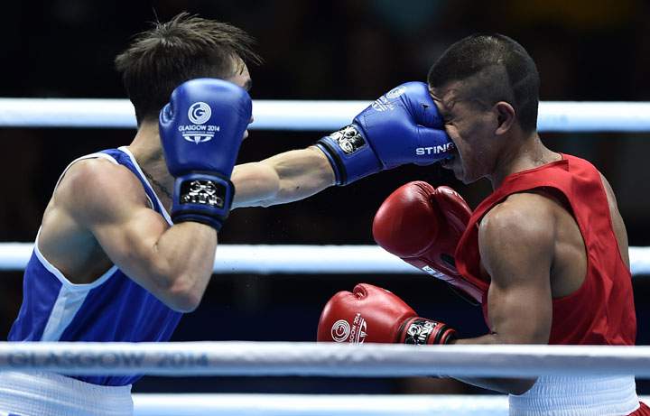 Northern Ireland’s Michael Conlan lands a punch on Nauru’s Mathew Martin during their men’s boxing bout during the 2014 Commonwealth Games in Glasgow, Scotland on July 25, 2014.