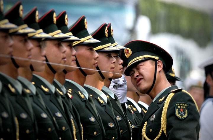 Chinese honour guards prepare for the arrival of Myanmar President Thein Sein and Chinese President Xi Jinping during a welcome ceremony outside the Great Hall of the People in Beijing on June 27,2014.