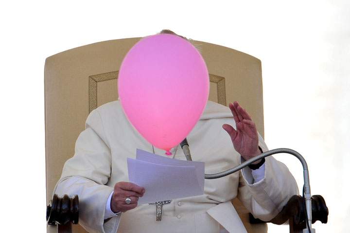 A balloon flies past Pope Francis during his general audience in St Peter’s Square at the Vatican on May 14, 2014.