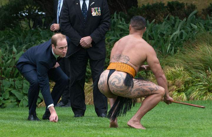 Prince William picks up a dart from a Maori warrior during a welcoming ceremony at Government House in Wellington on April 7, 2014.