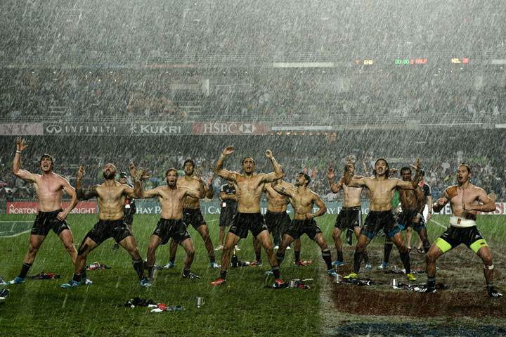 New Zealand players perform the “haka” in the rain after their victory over England in the final match of the three-day rugby sevens tournament at Hong Kong Stadium on March 30, 2014.