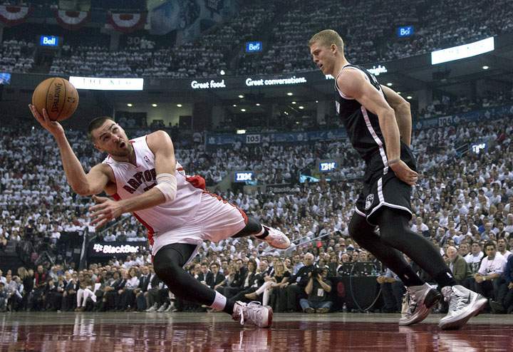 Toronto Raptors centre Jonas Valanciunas gets off a shot while tumbling during the first half of NBA playoff action in Toronto on Tuesday April 22, 2014.