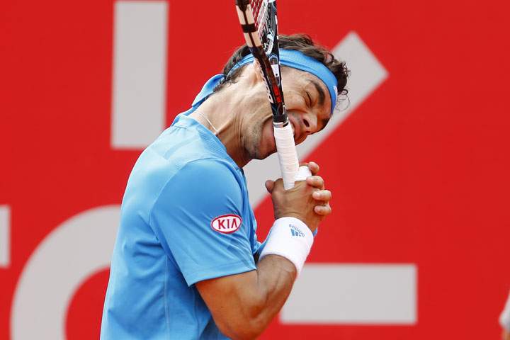 Fabio Fognini bites his racket during the final match of the Buenos Aires’ Copa Claro tennis Open against David Ferrer in Buenos Aires, Argentina, Sunday, Feb. 16, 2014.