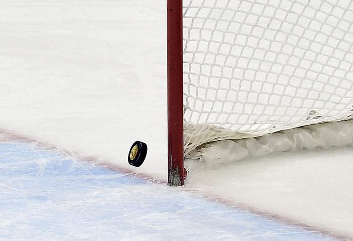 The puck hits the post with Canada’s goalie pulled in the last minutes of the game against United States during third period women’s hockey final action at the 2014 Sochi Winter Olympics in Sochi, Russia on Thursday, February 20, 2014.