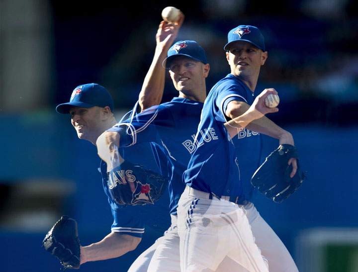 Toronto Blue Jays starting pitcher J.A. Happ, pictured in multiple exposures, throws against the Baltimore Orioles during first inning American League baseball action in Toronto on Saturday Sept. 27, 2014.
