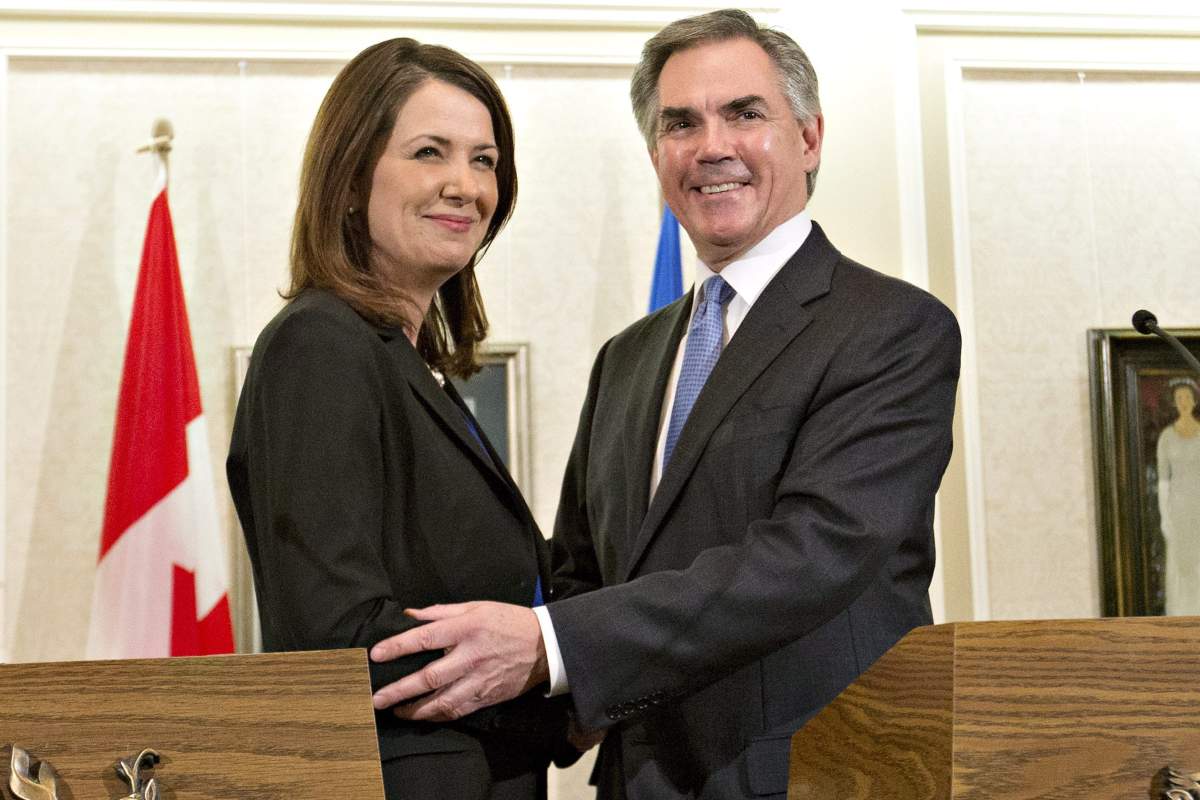 Alberta Premier Jim Prentice and former Wildrose Leader Danielle Smith speak to media after a caucus meeting in Edmonton Alta., Wednesday, December 17, 2014. Prentice’s caucus met to discuss a bid by at least half the official Opposition to cross the floor.