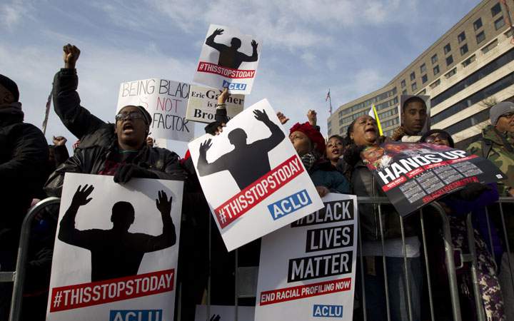 Demonstrators chant at Freedom Plaza in Washington, Saturday, Dec. 13, 2014, during the Justice for All rally and march.