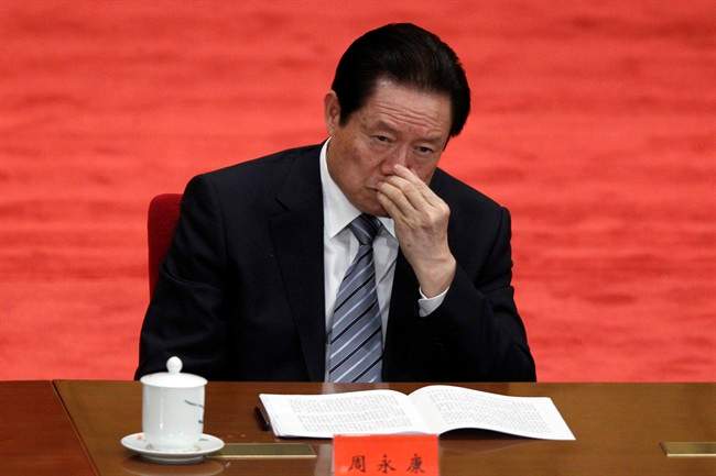 In this photo taken May 4, 2012, Zhou Yongkang, Chinese Communist Party Politburo Standing Committee member in charge of security, attends a conference to celebrate the 90th anniversary of the founding of Chinese Communist Youth League at the Great Hall of the People in Beijing. (AP Photo/Alexander F. Yuan, File).