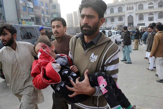 A Pakistani girl, who was injured in a Taliban attack in a school, is rushed to a hospital in Peshawar, Pakistan, Tuesday, Dec. 16, 2014. 