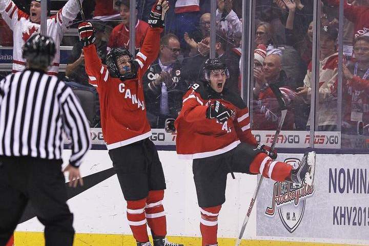 Nic Petan #19 of Team Canada celebrates his goal with teammate Connor McDavid #17 against Team Slovakia during a semi-final game in the 2015 IIHF World Junior Hockey Championship at the Air Canada Centre on January 4, 2015 in Toronto,